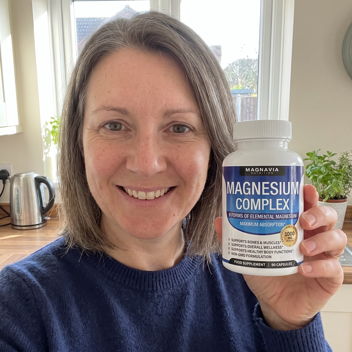 Sarah, 45 — holding Magnavia in her kitchen